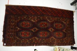 An old Persian bokhara type wall hanging, 142cm x 76cm.