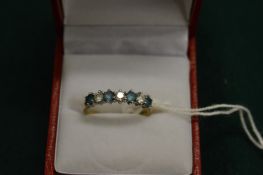 A 9ct gold dress ring set with seven alternating stones.