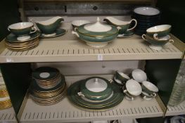 A dinner service decorated with green and gilt bands.