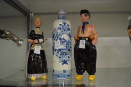 Two Bols pottery advertising figurines together with a Bols bottle.