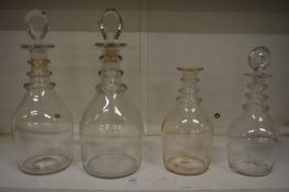 Two pairs of ring neck decanters, one lacking stopper.