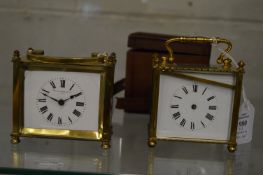 Two brass carriage clocks, both with faults together with a leather travelling case.