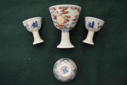A pair of miniature Doucai pedestal cups and two other items similar.