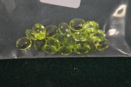 A collection of green gemstones, possibly peridot.