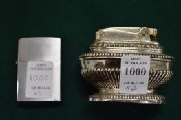 A Ronson table lighter and a Zippo lighter.