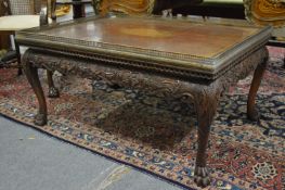 A mahogany rectangular coffee table with shell inlaid decoration, brass gallery top, supported on