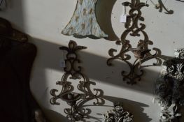 A pair of wrought iron wall mounted candle holders.