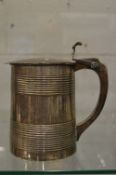 A Georgian silver lidded tankard with engraved hinged cover, the body with two pairs of