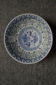 A Chinese blue and white circular bowl.