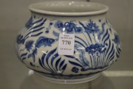 A Chinese blue and white circular bowl painted with fish.