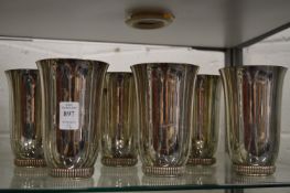 A set of six plated beakers.