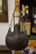 An Eastern metal mounted water bottle.