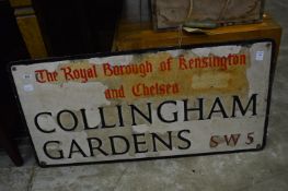 A Royal Borough of Kensington and Chelsea street sign and two speed limit signs.