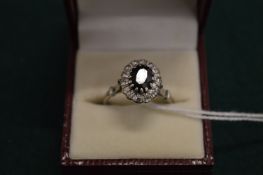 A white gold, diamond and sapphire ring.