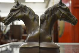 A pair of bronze horse head book ends.