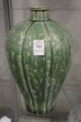 A large Chinese vase with green glazed and incised decoration.