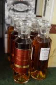 Six miniature bottles of Rastignac XO cognac.