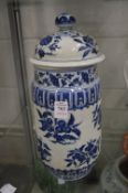 A Chinese blue and white decorated cylindrical vase and cover.