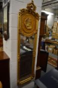 A pair of French style gilded narrow wall mirrors.