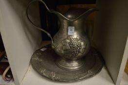 A pewter jug and dish.