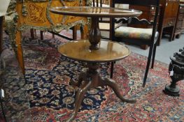 A mahogany two-tier circular dumb waiter.