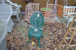 A pair of folding wooden chairs and a green painted aluminium chair.