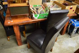 A chunky dining table with six chairs.