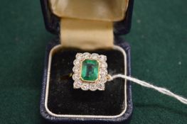 A good gold, diamond and emerald ring, the central emerald measuring approx 9mm x 6mm.