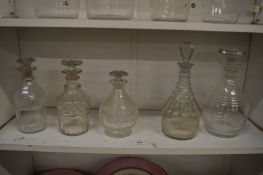 A collection of five various decanters.