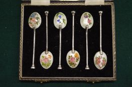A good cased set of six silver and floral enamel decorated coffee spoons.