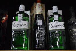 Two bottles of Gordons gin and a bottle of Norfolk Punch.