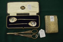 A silver aid memoire with engraved decoration, a pair of silver grape scissors and a cased pair of