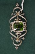 A very good large gold, diamond and peridot brooch, the central emerald cut peridot framed by