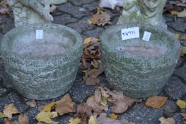 A pair of small reconstituted stone pots.