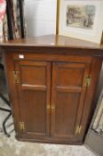 A 19th century oak hanging two door corner cupboard.