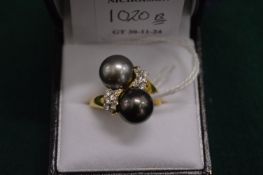 An 18ct gold, diamond and pearl crossover ring.