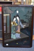 A Chinese reverse painting on glass depicting two female figures by a building.