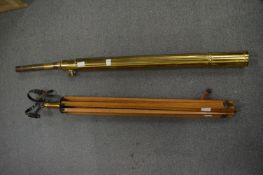 A brass telescope with tripod.
