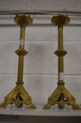 A pair of gilt cast metal candle stands.