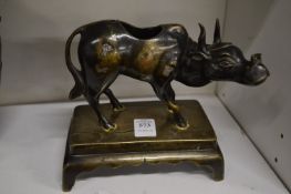 An Indian bronze figure of a bull on a rectangular base.