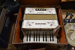 A boxed Hohner Student accordian.