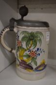 A large Continental tin glaze tankard with pewter lid.