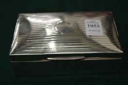 A silver cigarette box.