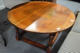 An oak circular coffee table.