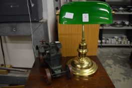 A brass desk lamp and a model traction engine.