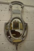 Decorative shaped mirror with silver painted frame.