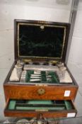 A good Victorian rosewood vanity box containing a fitted interior with cut glass and silver topped