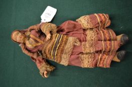 An early 20th century felt doll with original clothing.