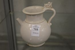 A small Chinese pale celadon glazed ewer.