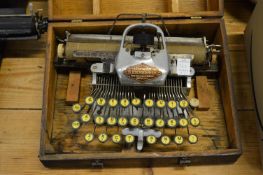 A Blickensderfer Featherweight aluminium typewriter and two other typewriters.
